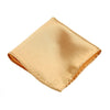 Ein gefaltetes Premium-Seiden-Einstecktuch in hellem Gold oder Champagner.