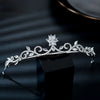A sparkling cubic zirconia bridal tiara headband displayed on a black surface.