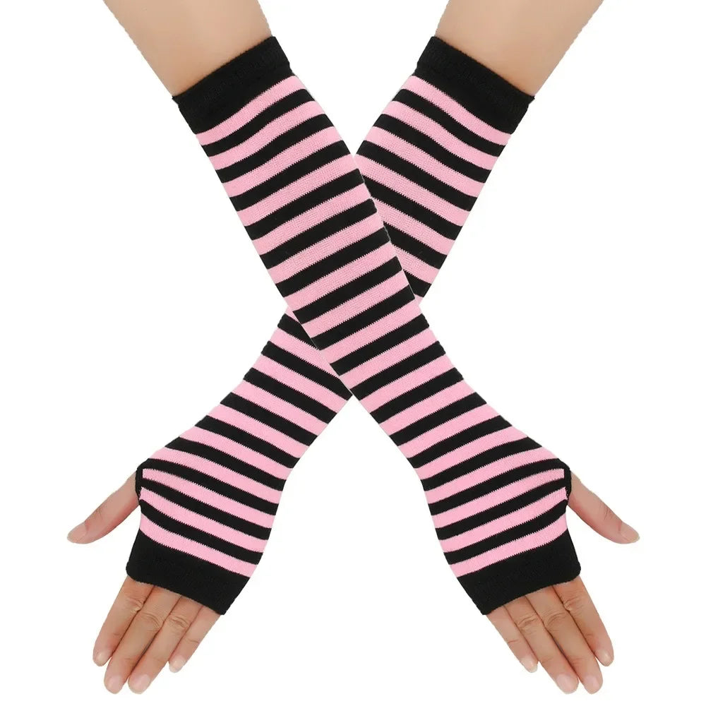 Elegant knitted fingerless gloves with black and pink stripes crossed on a hand