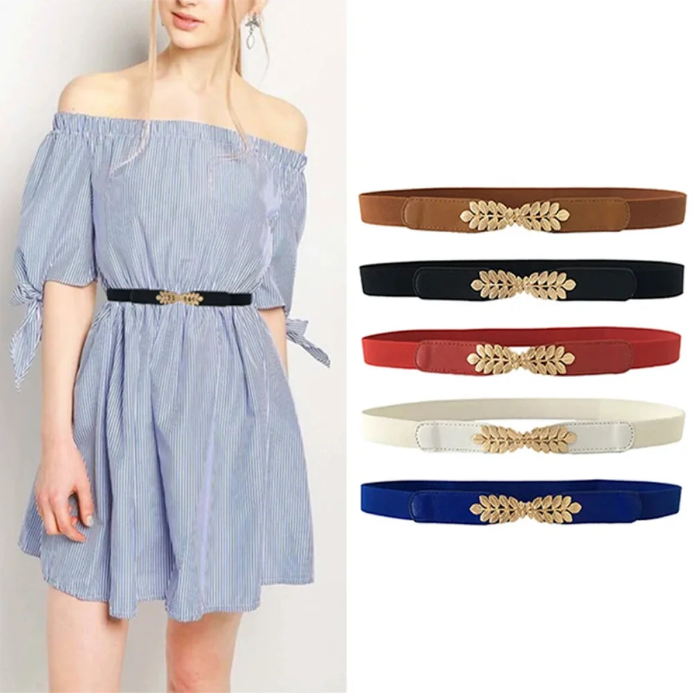 A woman models a light blue striped dress and various colored leather elastic waistbands with gold embellishments.