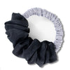 A black velvet heatless hair curling scrunchie with a light gray fabric band.