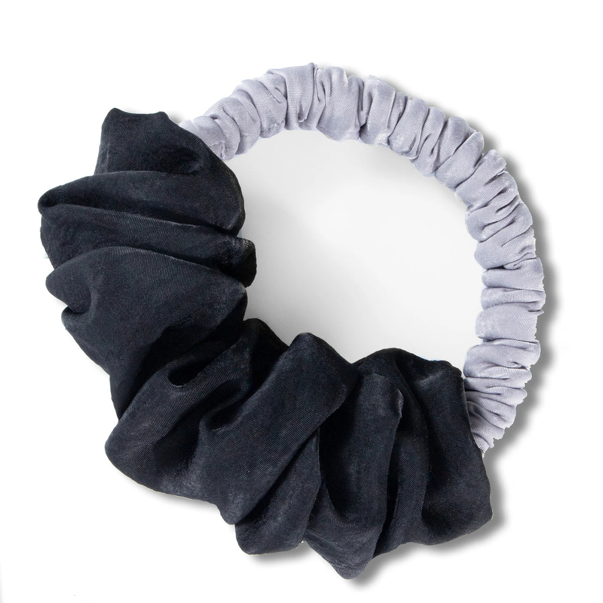 A black velvet heatless hair curling scrunchie with a light gray fabric band.