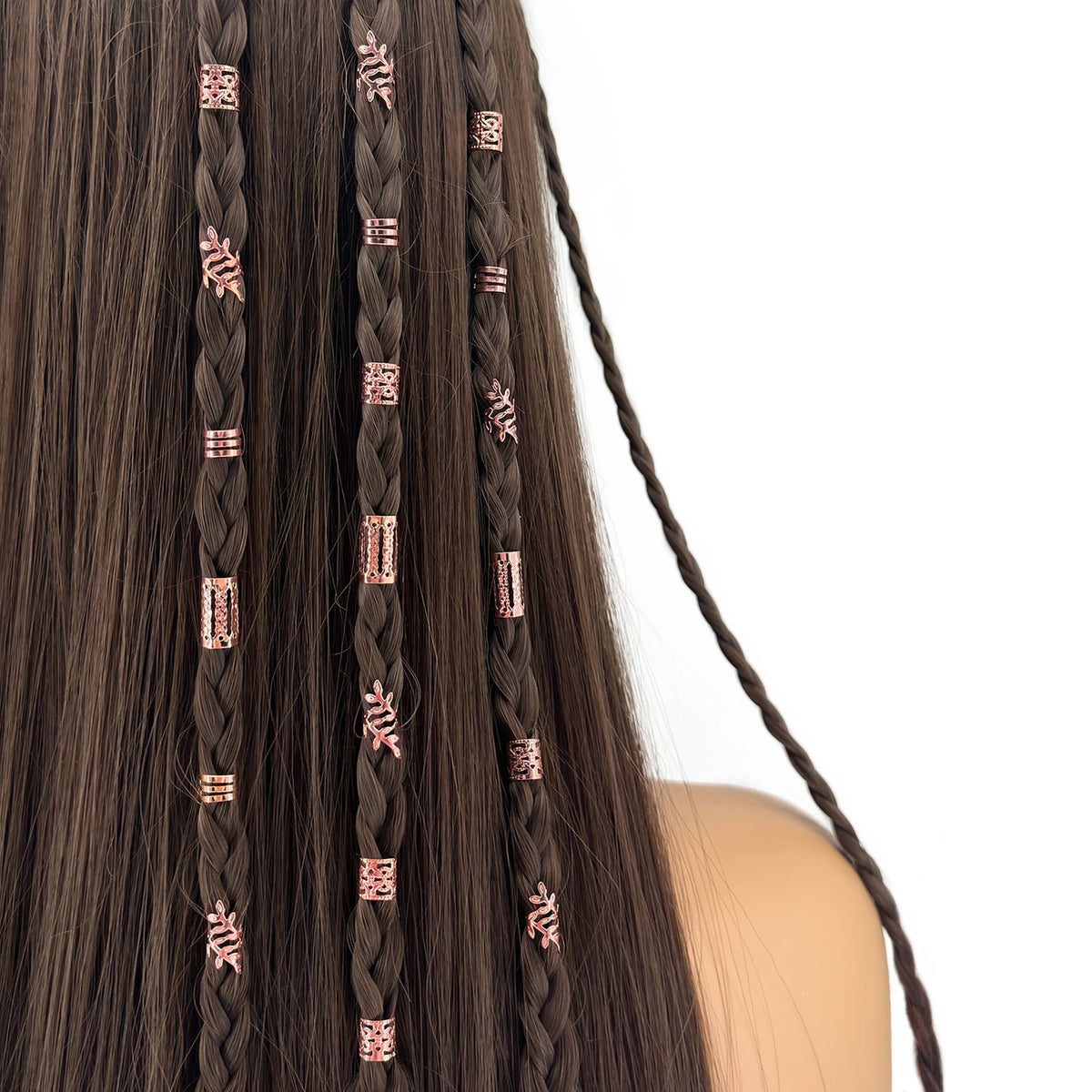 Close-up of dark brown hair braided with elegant rose gold hollow rings