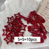 A set of ten red star snap clips for hair and barrettes displayed on white paper.