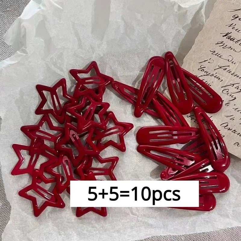 A set of ten red star snap clips for hair and barrettes displayed on white paper.