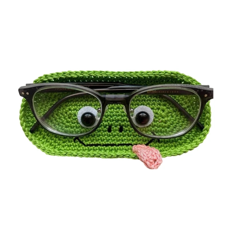 Handmade crochet animal storage case shaped like a green frog holding a pink yarn ball.