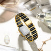A gold and black ceramic fashion wristwatch is displayed on a white surface with other accessories.