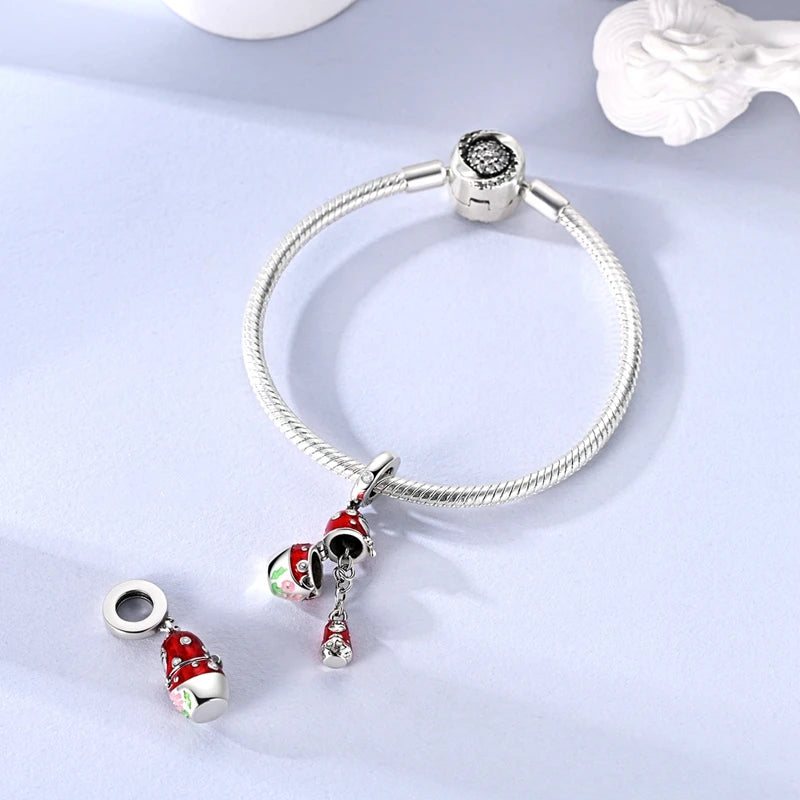 Sterling silver devil's eye charm bracelet with a silver bead and red and green charms