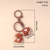 A brown classic coffee keychain featuring a small cup and saucer, shown with dimensions.
