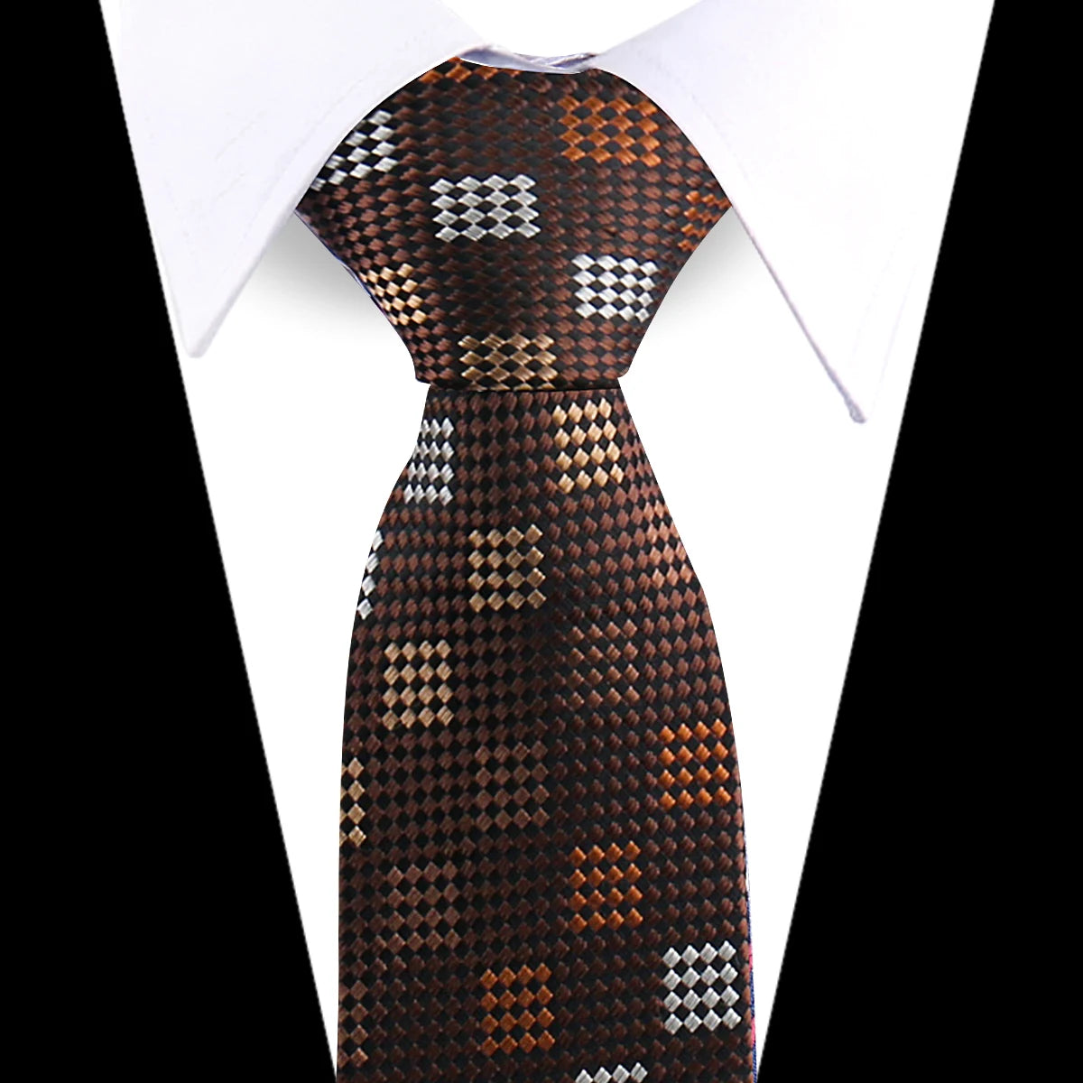 A close-up of an elegant men's floral paisley silk necktie in brown and silver tones against a white shirt.