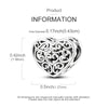 A sterling silver heart-shaped charm with intricate scrollwork and a small moon design.