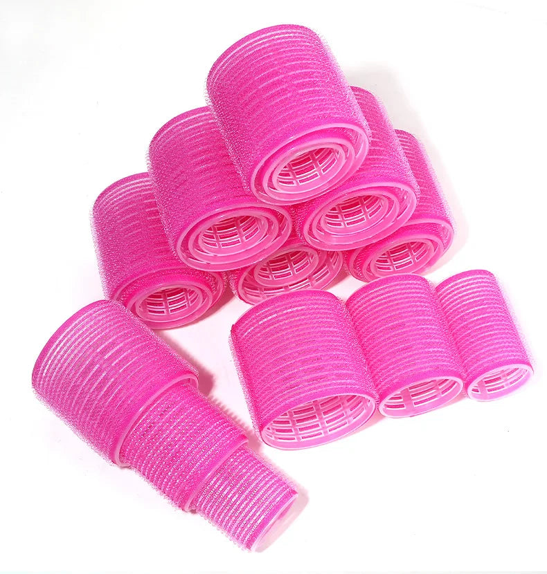 A stack of bright pink heatless hair curlers for DIY styling.