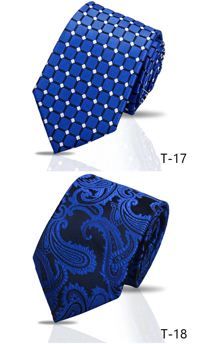 A pair of men's silk neckties, one blue patterned and one navy blue floral paisley.