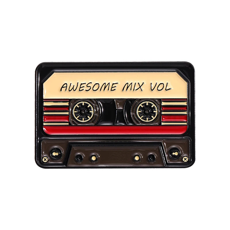 A black cassette tape enamel pin featuring the text AWESOME MIX VOL and red stripes.