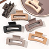 A set of seven square hair claw clips in various neutral tones including beige, taupe, and black, displayed on a light backgr