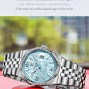 A silver quartz wristwatch with a light blue face and textured metal band resting on a red surface.