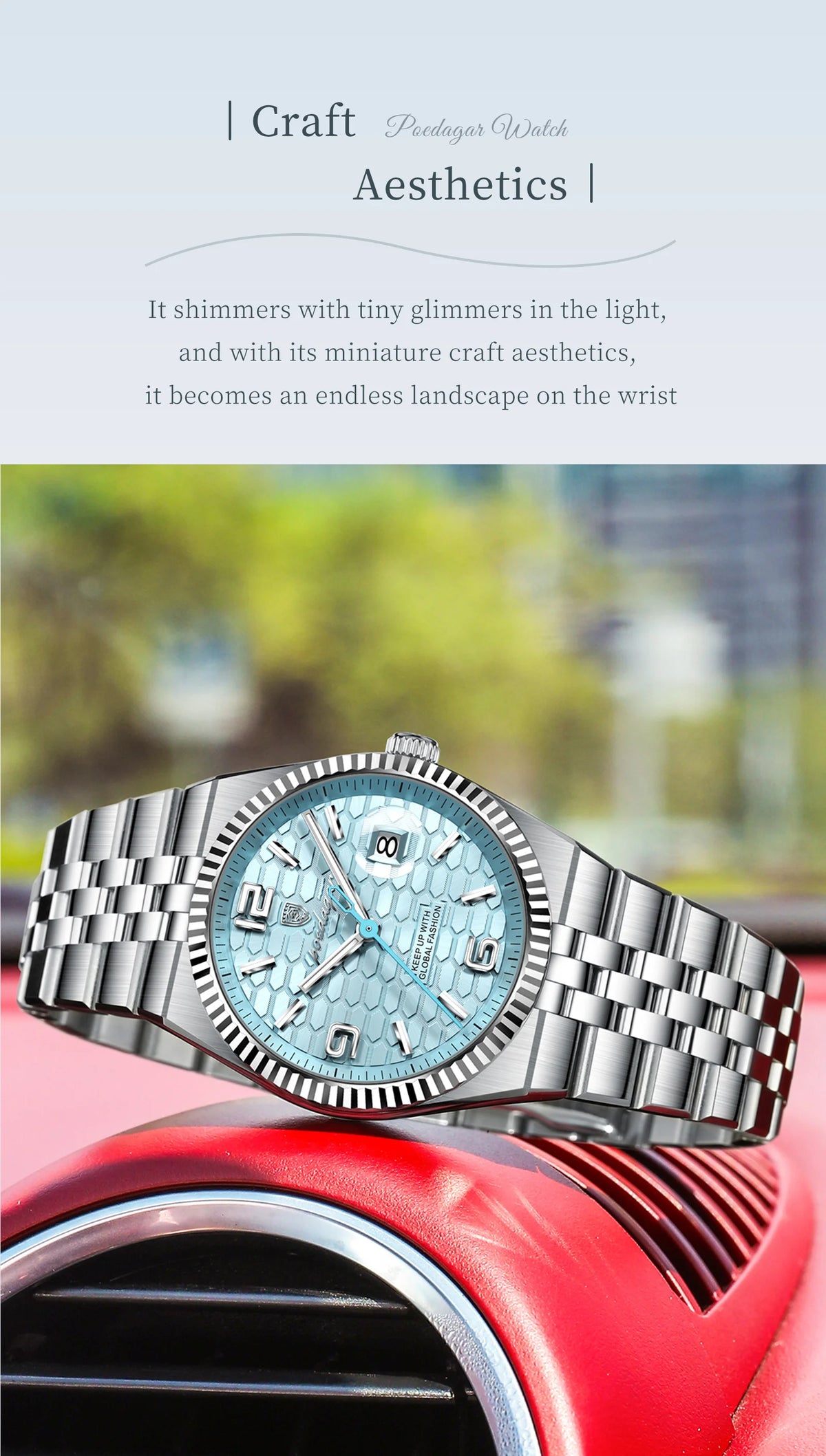 A silver quartz wristwatch with a light blue face and textured metal band resting on a red surface.