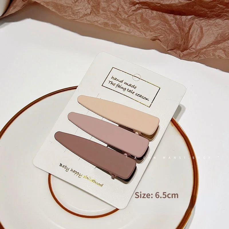 A set of vintage frosted geometry hair clips in various shades of pink and nude, displayed on a white background.