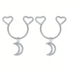 A pair of silver heart dangle non-piercing nipple rings adorned with cubic zirconia stones.