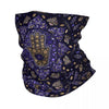 A dark purple and gold patterned bandana neck gaiter featuring a stylized hamsa hand design.