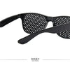 Black vision correction pinhole glasses with a mesh lens and flexible arms shown from the back display