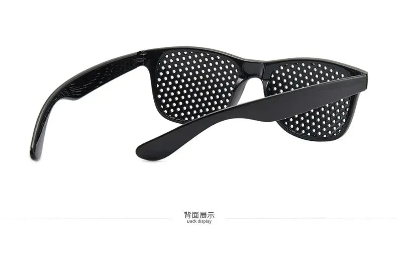 Black vision correction pinhole glasses with a mesh lens and flexible arms shown from the back display
