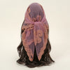 A purple floral embroidered lace bandana headscarf tied around dark hair.
