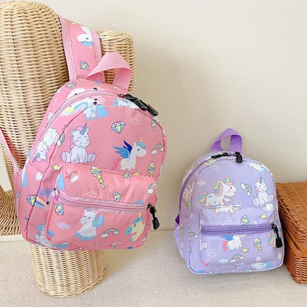 A pink and purple unicorn dinosaur pattern kids backpack is displayed next to a woven basket.