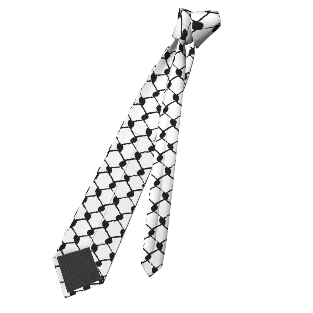 A black and white patterned neck tie featuring a traditional Arabic keffiyeh design.