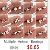 Collection d'boucles d'oreilles en argent en forme de cœur et d'animaux, portées sur divers doigts.