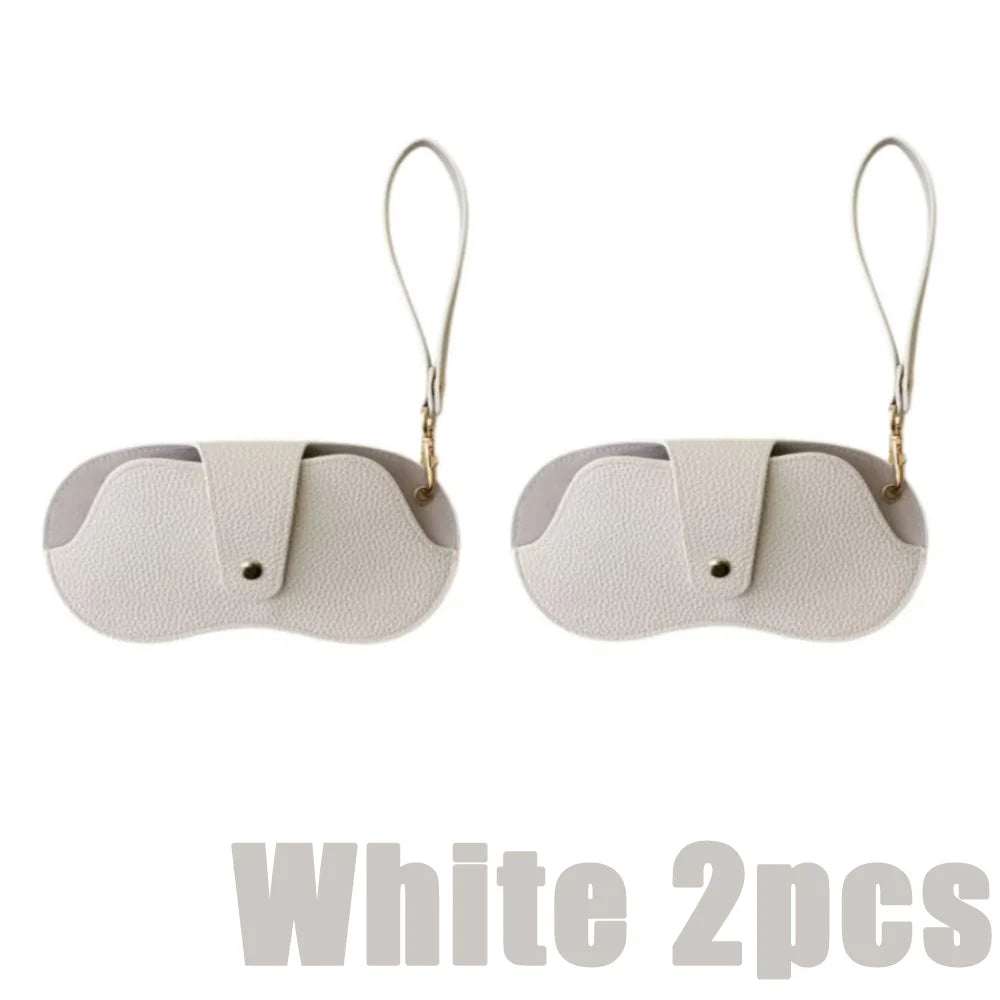 Two white PU leather eyewear storage cases with gold-colored ear loops.