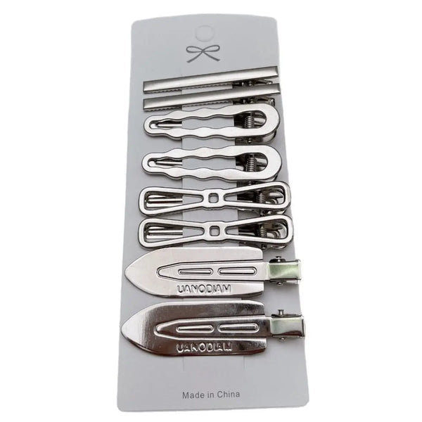 A set of vintage silver Y2K metal hair clips and accessories packaged in a light gray holder.
