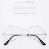 Un par de gafas redondas de metal con monturas delgadas y lentes oscuros, mostradas sobre un fondo blanco.