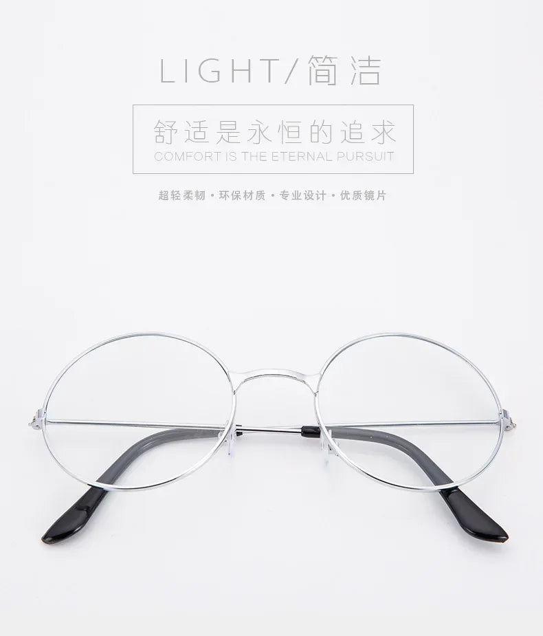 Un par de gafas redondas de metal con monturas delgadas y lentes oscuros, mostradas sobre un fondo blanco.