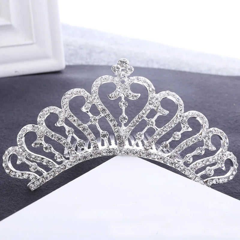 A sparkling crystal princess tiara hair comb for women displayed on a white background.
