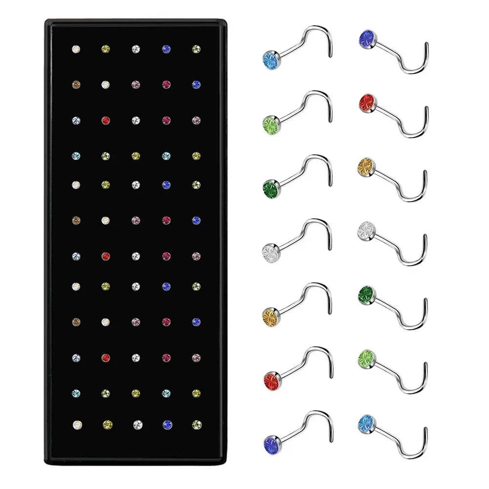 A set of stainless steel nose studs and body piercing jewelry for various piercings.