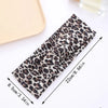 A black and brown leopard print fabric headband is shown laid out with measurements.