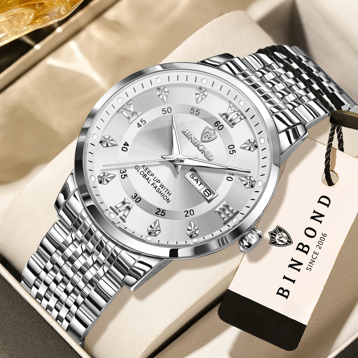 A silver and black Luminous Quartz wristwatch with a metal bracelet resting on a light beige surface.