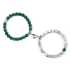 A pair of natural stone heart couple bracelets, one green and one clear, displayed on a white background.