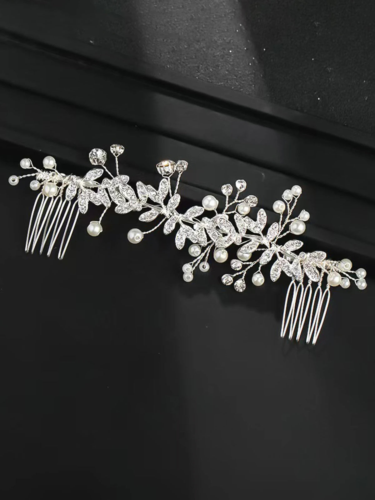 Elegant silver leafed crystal hair comb featuring delicate leaves and pearl accents.