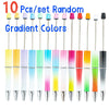 A set of ten gradient colored ballpoint pens in various shades including yellow, pink, green, and orange.