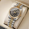 A gold-toned quartz wristwatch with a silver bracelet and round face is displayed on a light background.