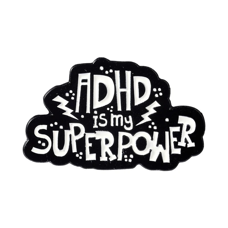 Black enamel lapel pin featuring the text ADHD is my superpower with lightning bolt accents.