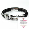 A black leather knot bracelet with a silver engraving that reads I love you forever