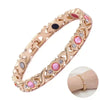 A close-up of a gold energy bracelet featuring sparkling geometric stones and a textured design.