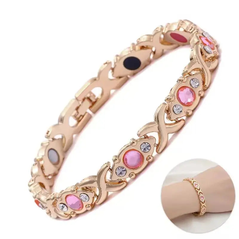A close-up of a gold energy bracelet featuring sparkling geometric stones and a textured design.