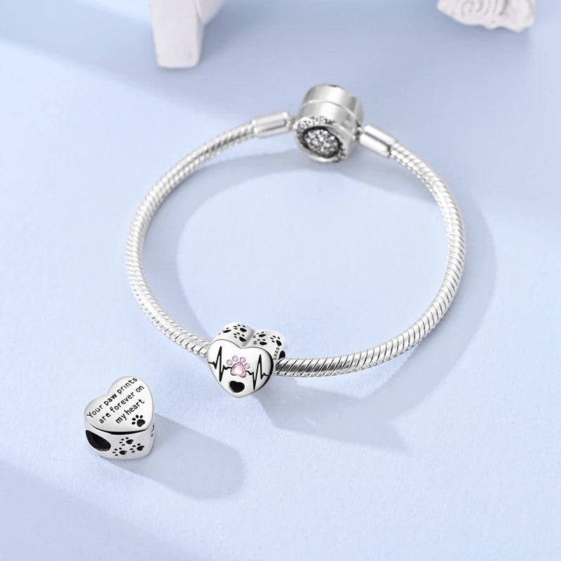 Sterling silver devil's eye charm bracelet with a heart pendant and a charm on the clasp