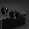 A pair of classic square sunglasses with dark lenses and a brown frame resting on a black box.