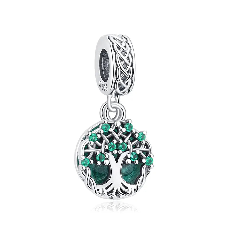 A sterling silver family tree charm featuring a detailed tree design with green gemstones.