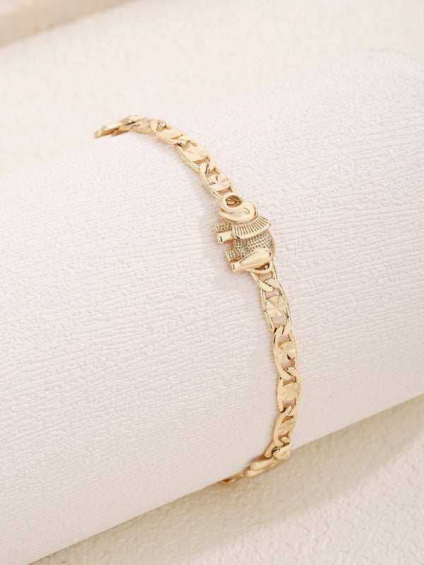 Gold fashion bracelet featuring an elephant carving design worn on a white wrist.